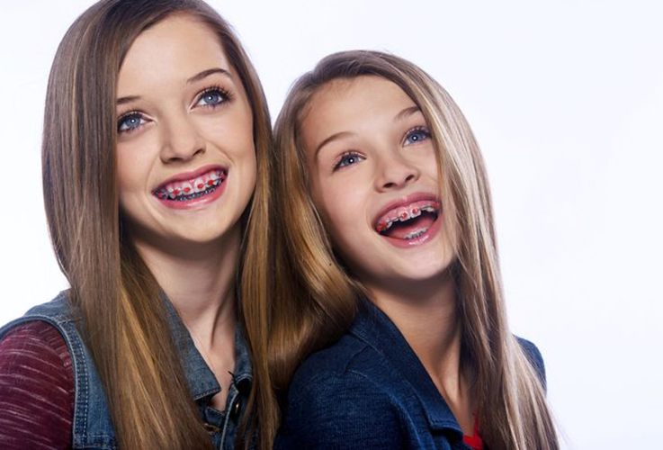 Two girls with red bracket braces