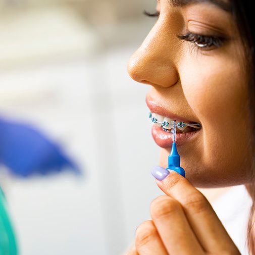 Woman cleaning her braces