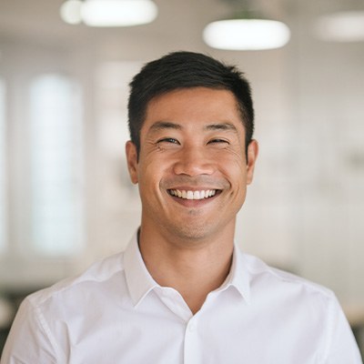 Man in white button-up shirt smiling