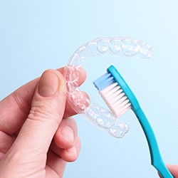 Patient cleaning clear aligner with toothbrush