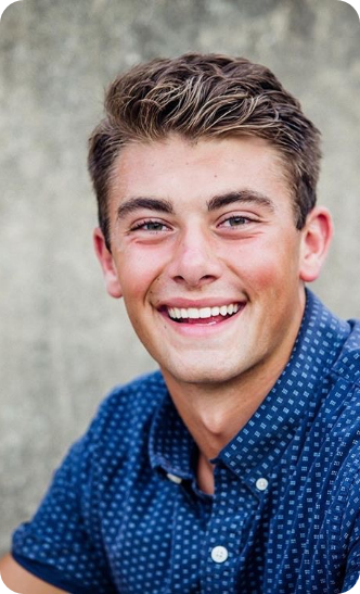 Young man in button up shirt smiling