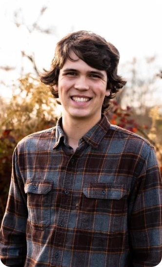 Young man with patterned shirt smiling