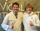 Orthodontist and patient giving thumbs up