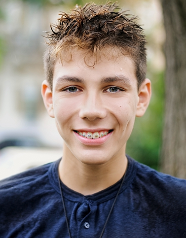 Two young boys smiling with braces