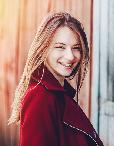 Girl with braces and beanie smiling